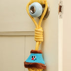Yellow knotted rope toy with a blue and brown plush dog toy attached to a doorknob.