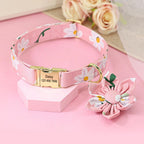 Floral-patterned dog collar with a nameplate on a pink surface