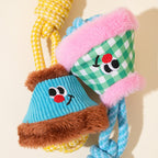Colorful dog toys with faces on a beige background