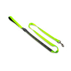 Neon green and black dog leash on a white background