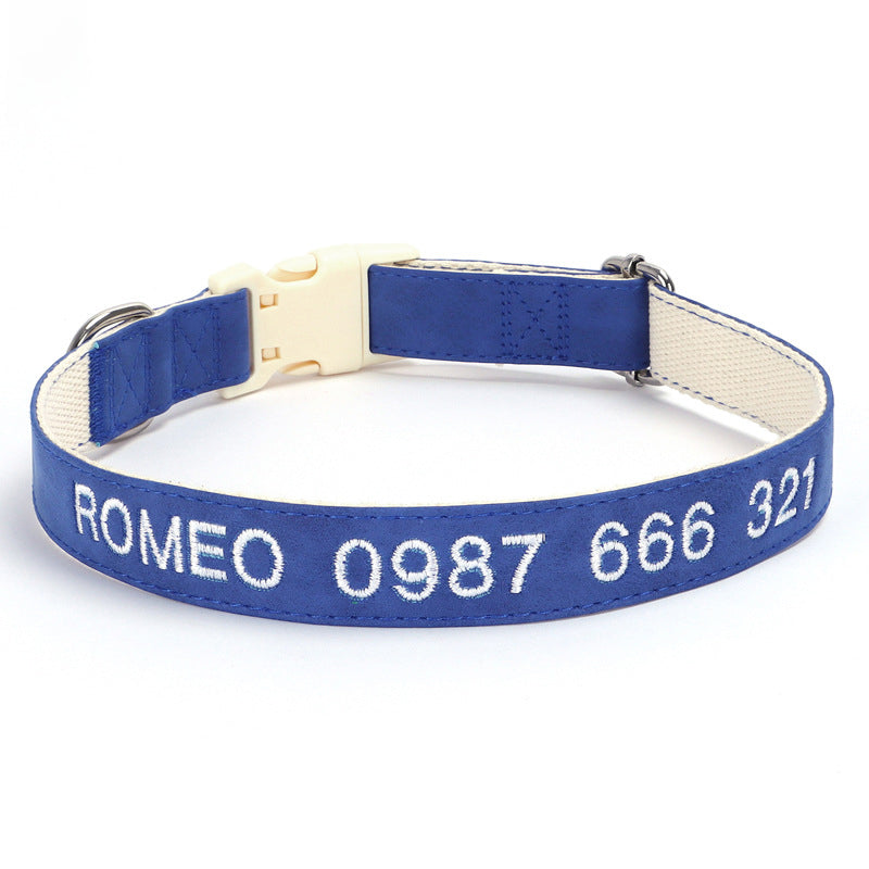 Blue dog collar with white text on a white background
