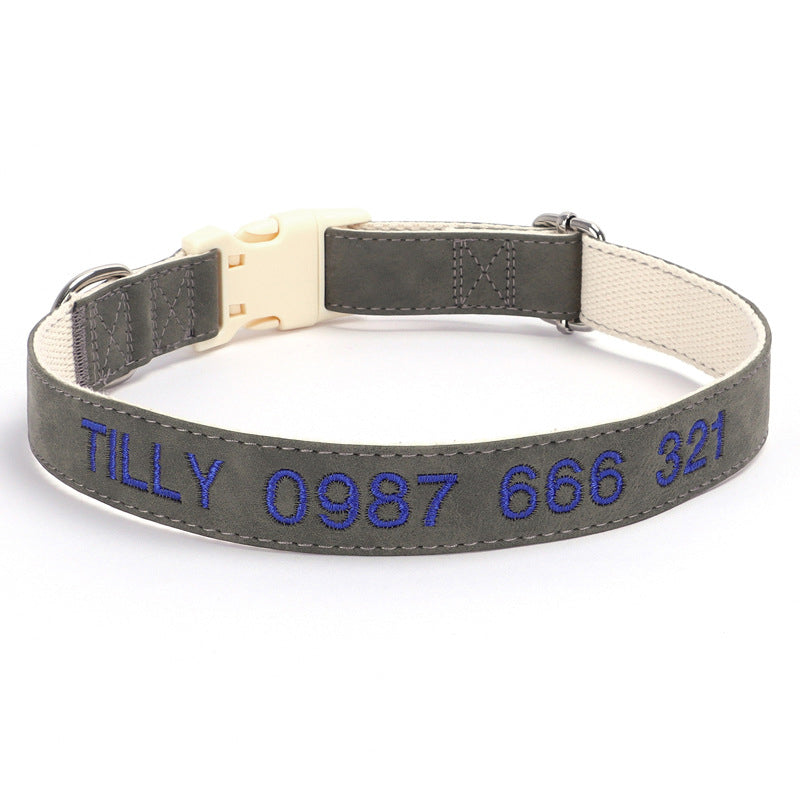 Gray dog collar with embroidered blue text on a white background