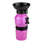 Pink pet water bottle with black lid and holder on a white background