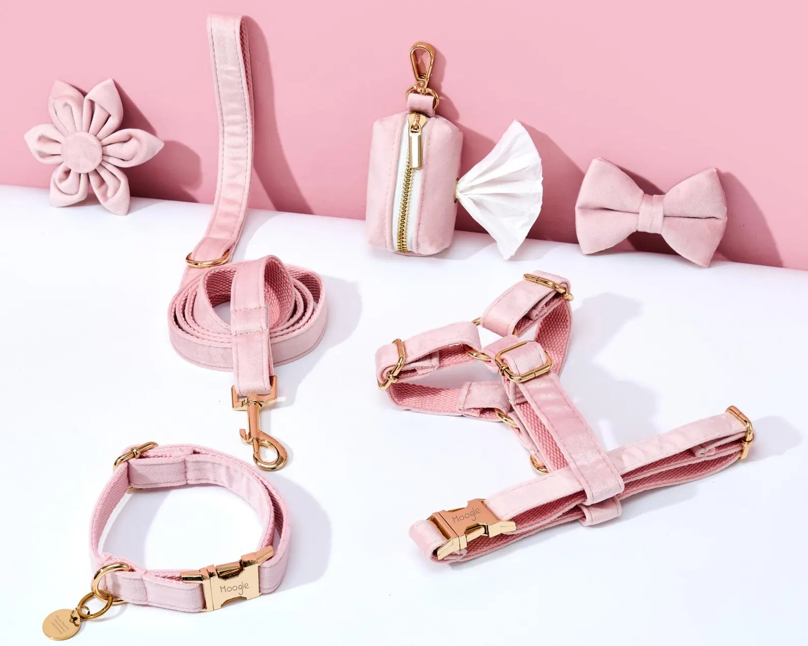 Pink pet accessories including a leash, collar, and harness on a white background with pink flowers.